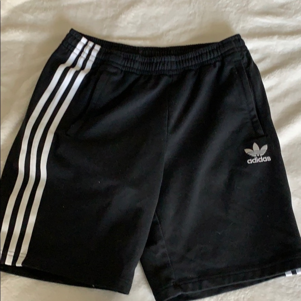 Adida shorts with white stripes.
